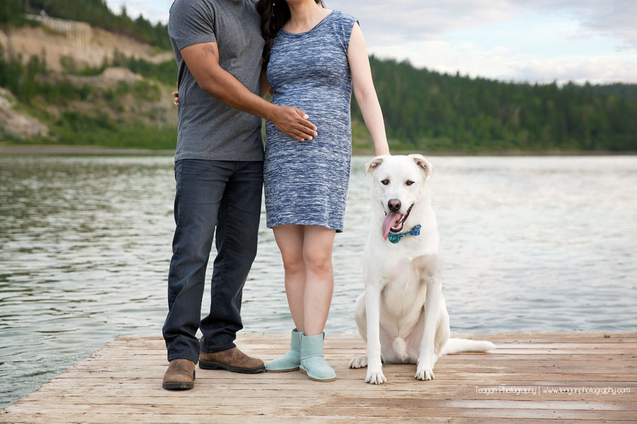 A mixed race couple pose on a dock along the North Saskatchewan River in Edmonton for maternity photos. 