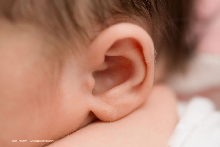 a close up of a newborn baby girl's ear in an Edmonton newborn photo session