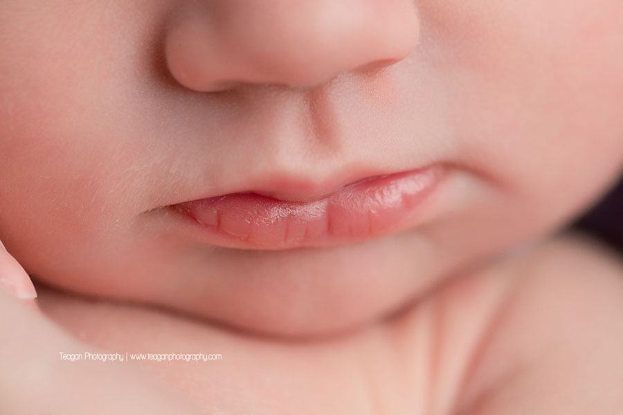 a close up photo of a newborn baby girl's lips