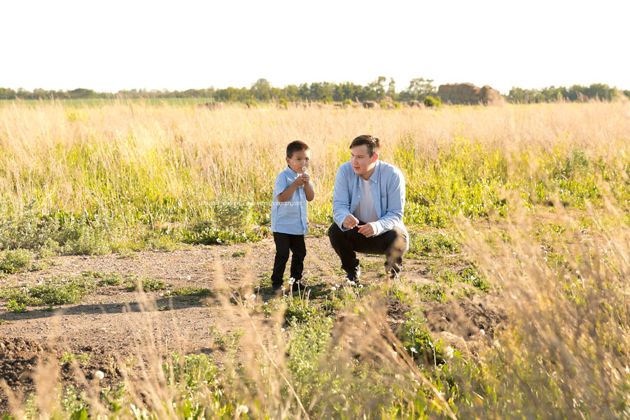 A dad and son play together in an Edmonton field