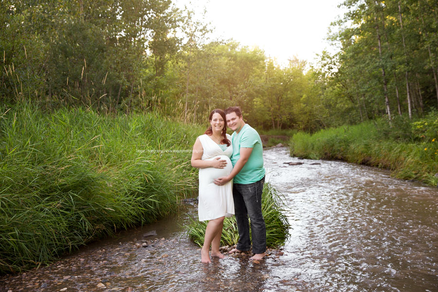 A husband and wife are expecting their first baby and celebrate with Edmonton maternity photos in the summer