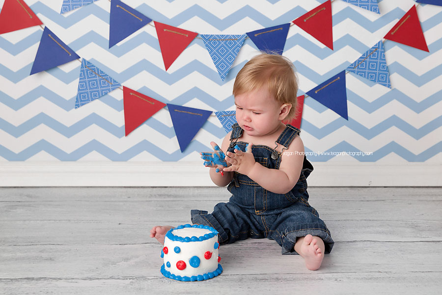 A one year boy celebrates his first birthday with a blue,white and red themed cake smash in Edmonton