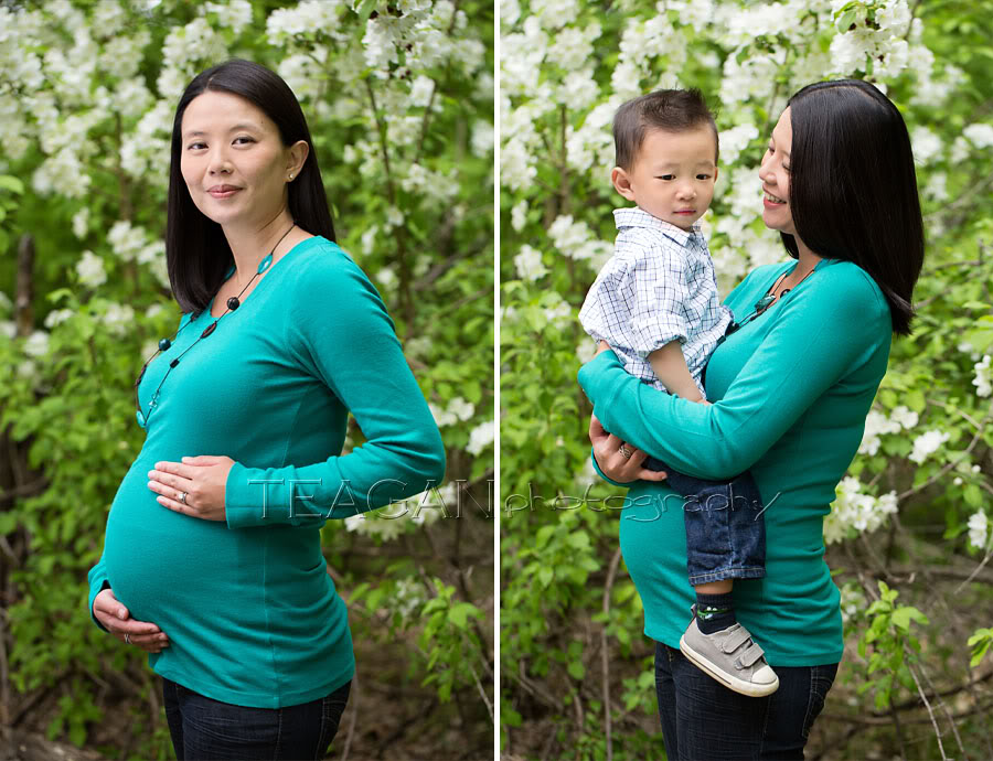 Pregnant mother in green dress posing under blooming apple trees in Edmonton River Valley