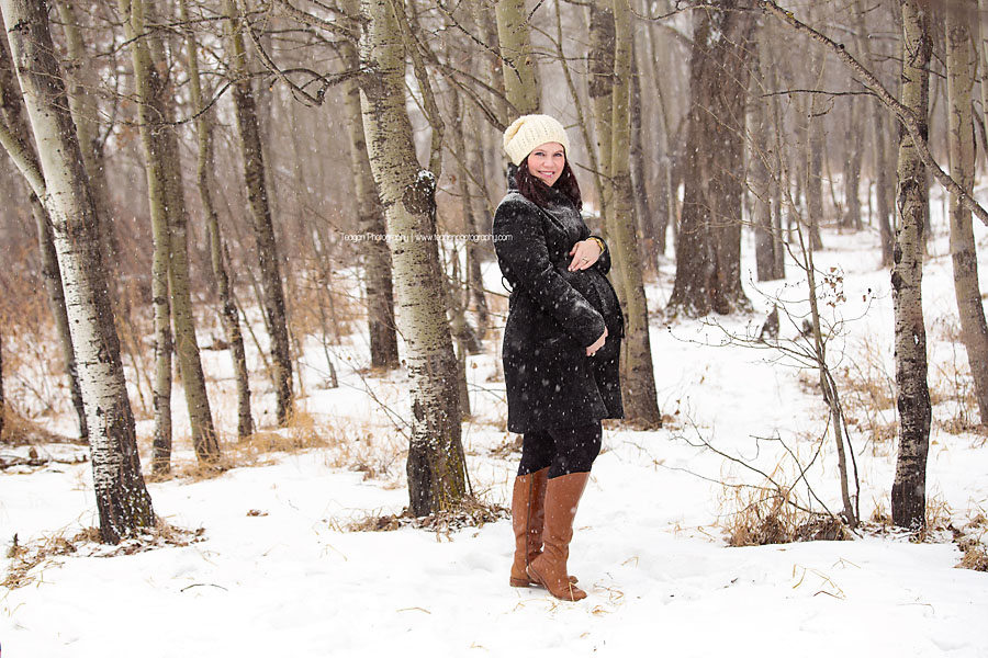 A pregnant Edmonton mother poses for winter maternity photos in Edmonton