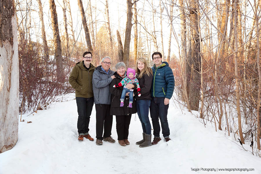 A large family poses together on a snowy path in St Albert