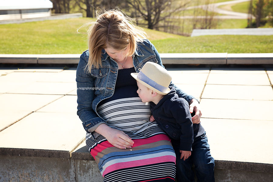 A little boy hugs his pregnant mom during an Edmonton maternity photo session