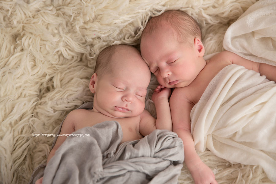 Twin babies  snuggle together during an  Edmonton newborn photography session