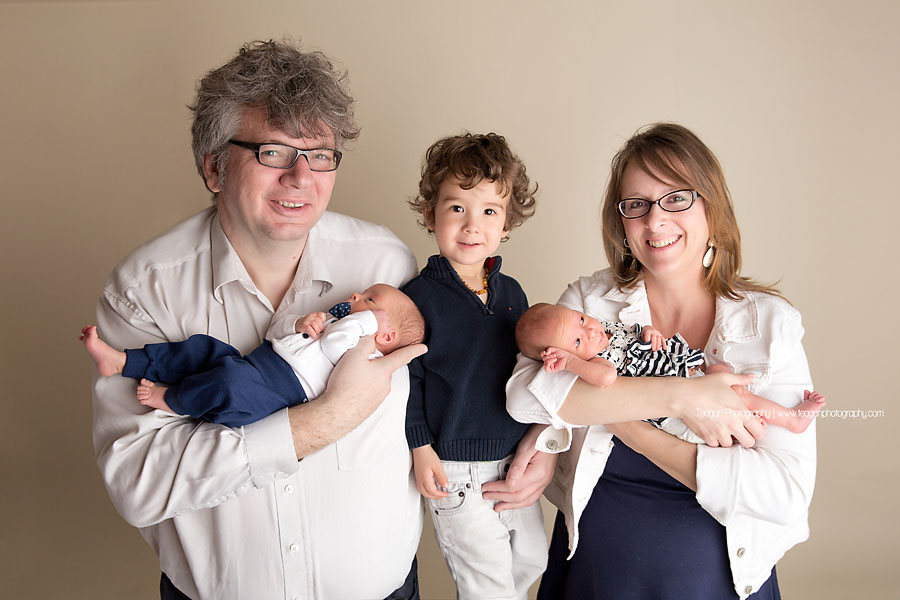 A new Edmonton family pose together with their twin babies and  preschool age son