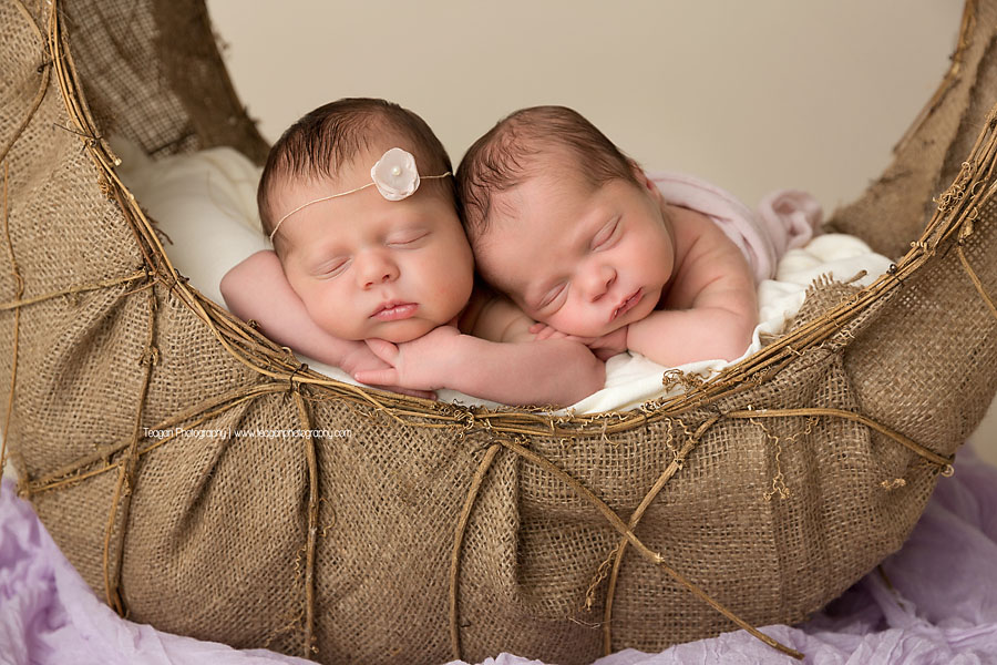 Baby twins sleep in a wicker basket during an Edmonton newborn photoshoot 
