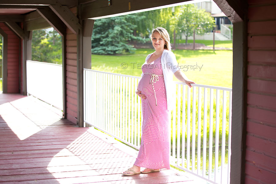 Standing in the sunshine at Woodbridge Park in Sherwood Park is a mother expecting a baby.
