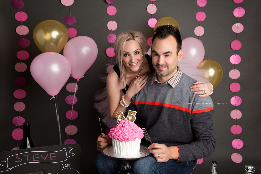 The husband of a woman sneaks in to steal some of her cake during her Edmonton cake smash photo shoot