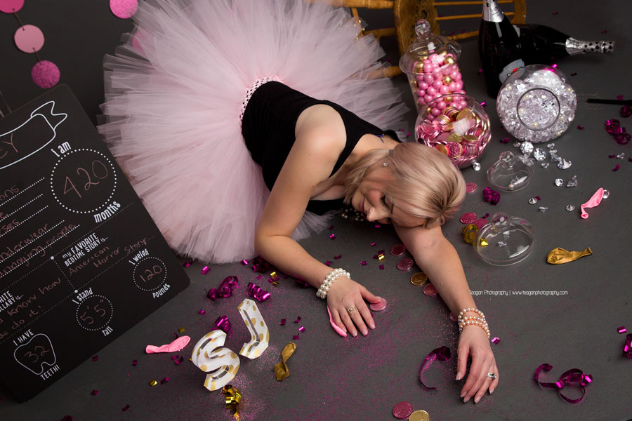 The birthday girl is passed on on the floor of glitter and sparkles