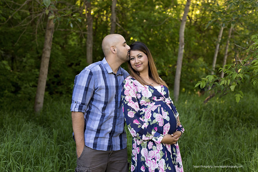 Pregnant mother posing elegantly by a shallow creek in the Edmonton Millcreek ravine during summer
