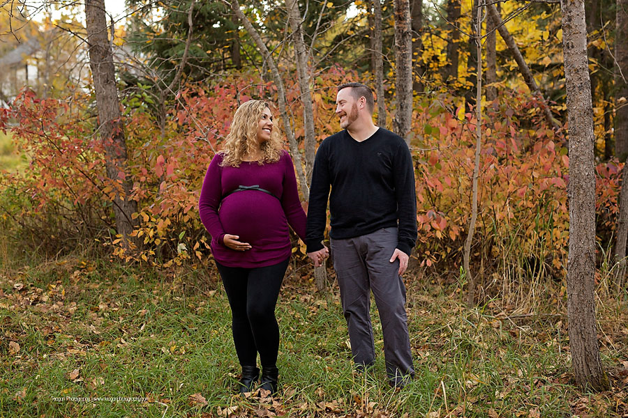 YEG family photographer capturing outdoor fall maternity photos with orange and yellow foliage