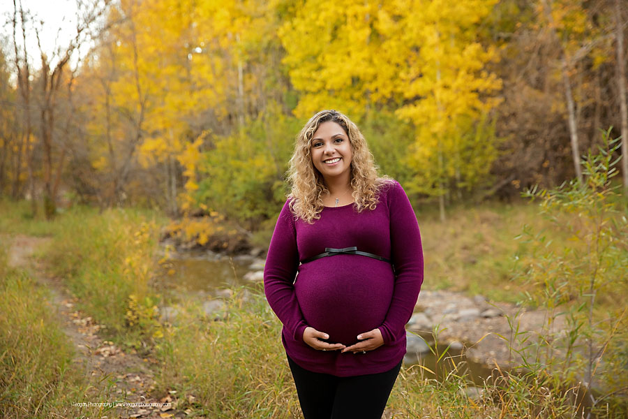 YEG family photographer capturing outdoor fall maternity photos with orange and yellow foliage